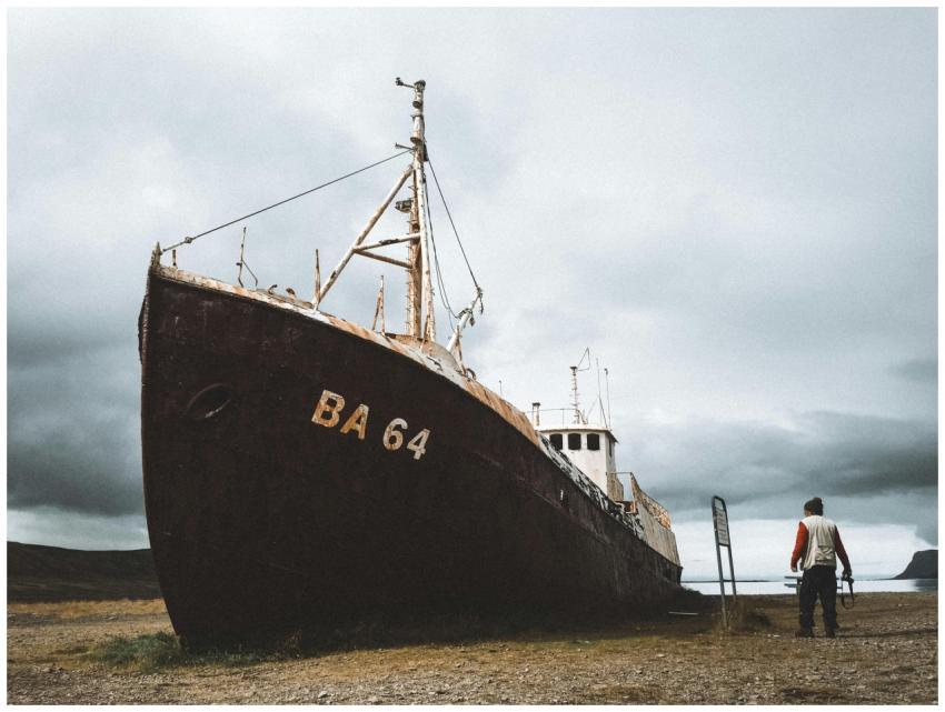 An atmospheric photo of an abandoned ship and lone