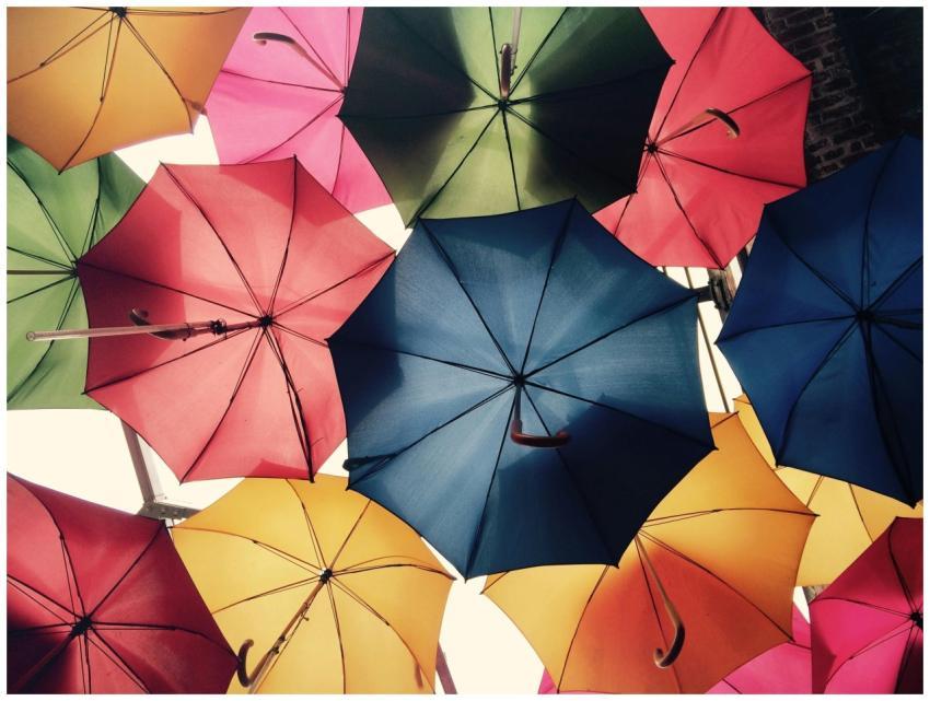 Vibrant umbrellas create a colorful canopy in Grea