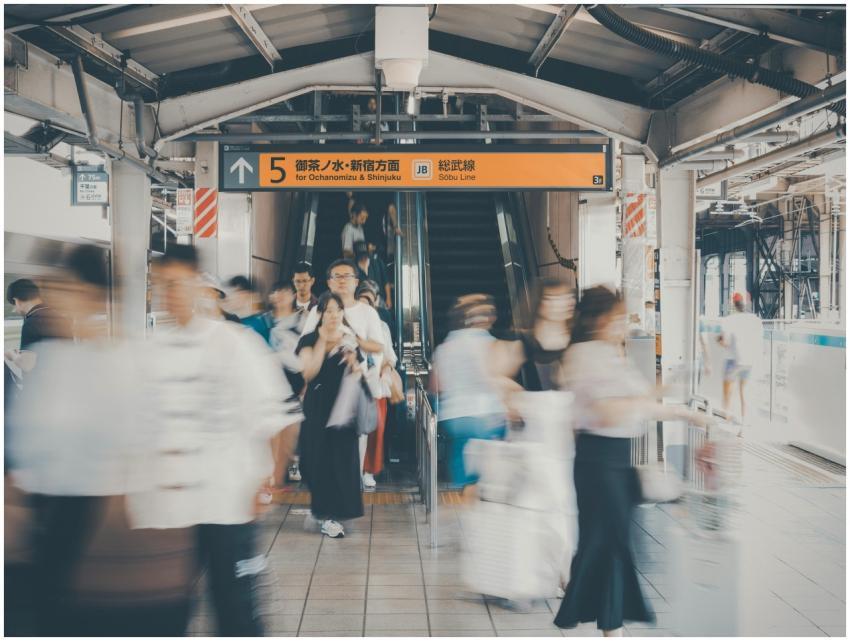 Blurred commuters at Shinjuku Station, Tokyo, capt