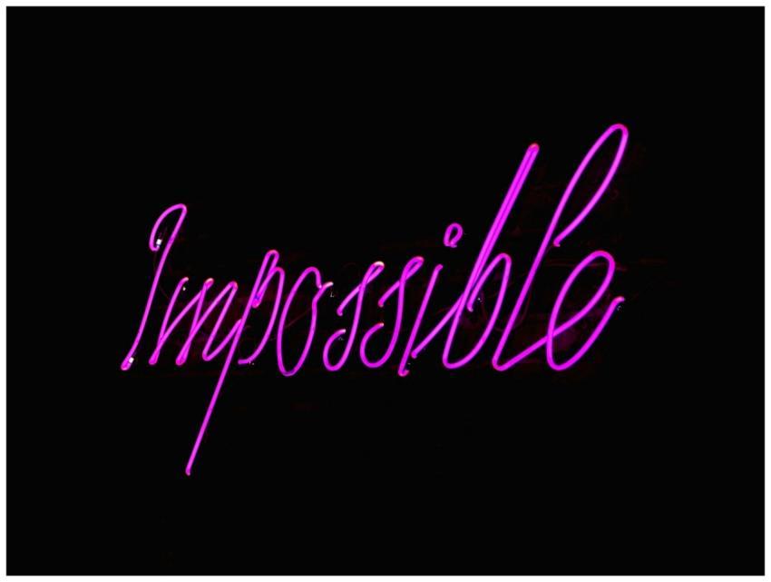 Eye-catching neon 'Impossible' sign glowing agains