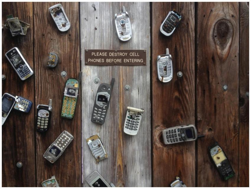 Collection of vintage cell phones attached to a ru