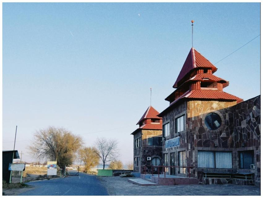 Stone building with red roofs in Konaev, Almaty Re