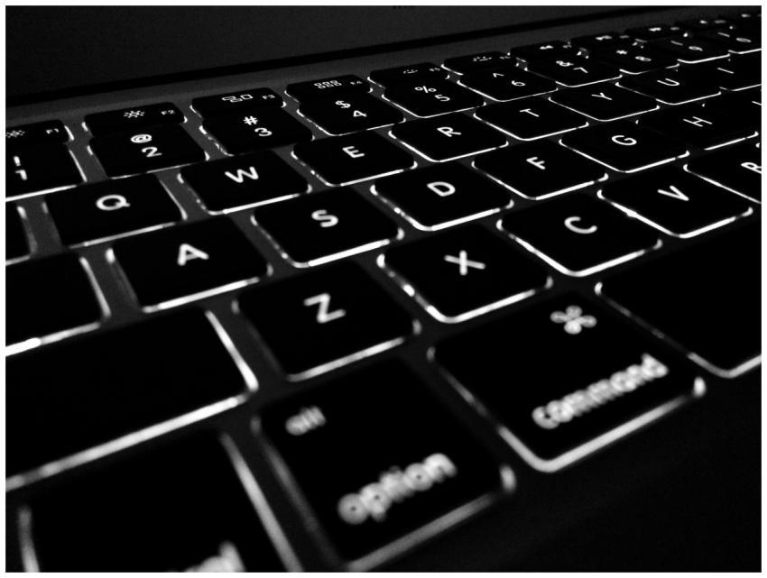 Black and white close-up of backlit keyboard, high