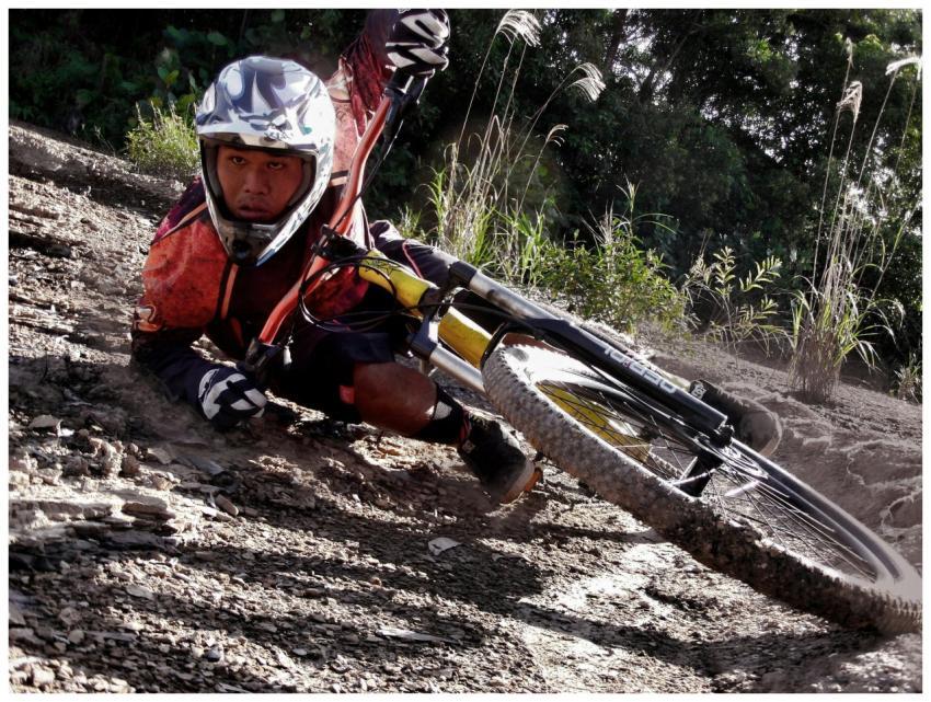 Close-up of a cyclist crashing on a dirt mountain