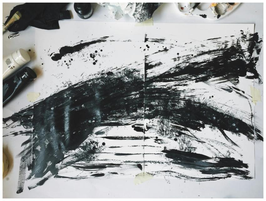 Abstract art featuring bold black brush strokes on