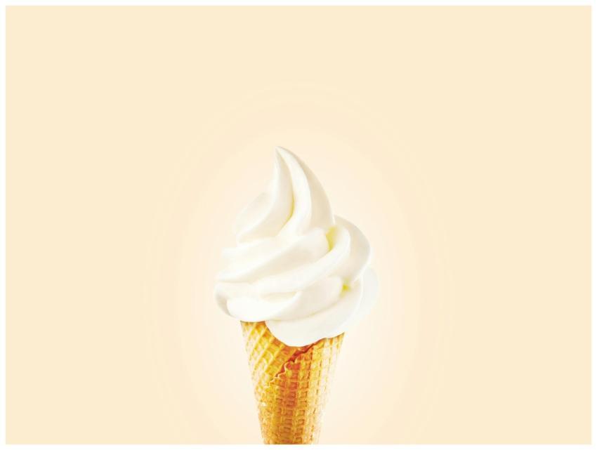 Close-up of a creamy soft serve ice cream cone on