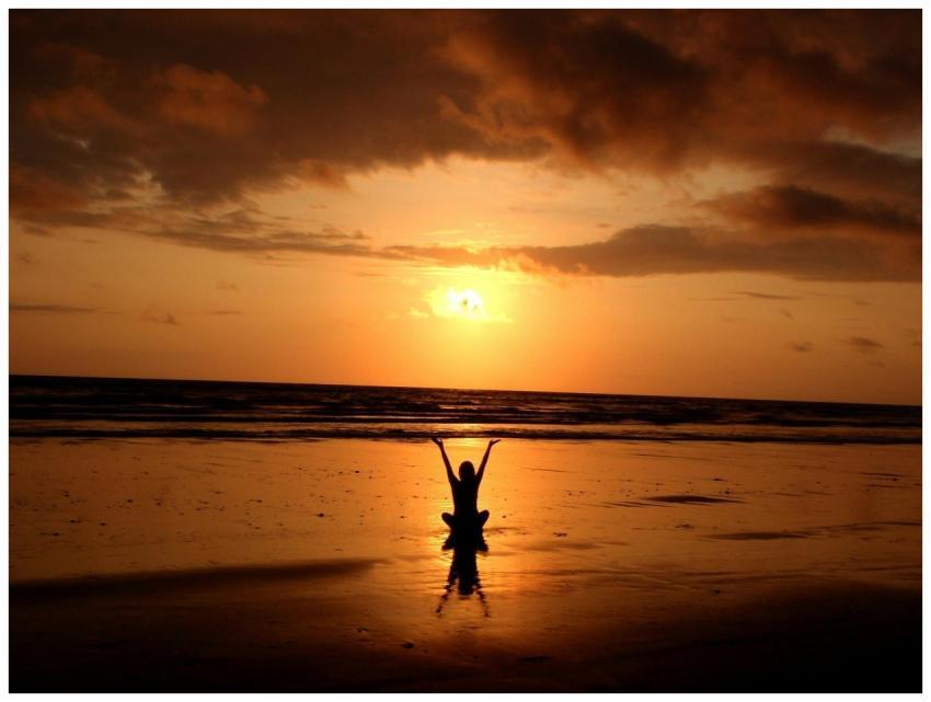 Peaceful meditation silhouette at sunset on a sere