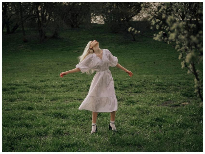 A young woman in a white dress enjoying a serene m