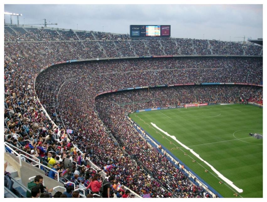A packed stadium with enthusiastic fans watching a