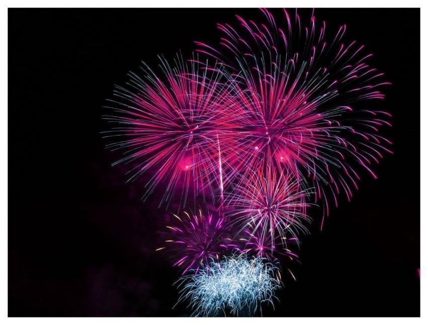 Colorful fireworks exploding in the night sky, cre