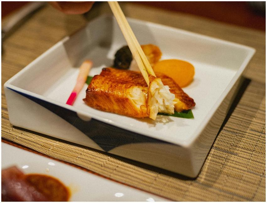 Elegant grilled fish dish with chopsticks in a Jap