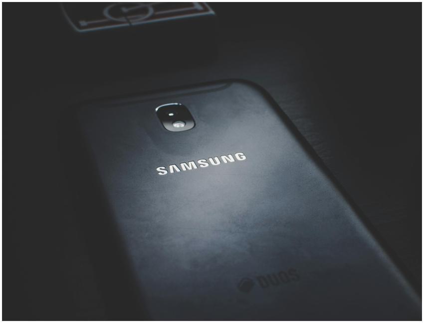 Detailed view of a smartphone on a dark wooden sur