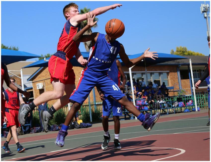 Two athletes playing a competitive basketball game