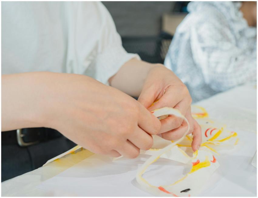 Close-up of hands crafting paper art in a Tokyo cl