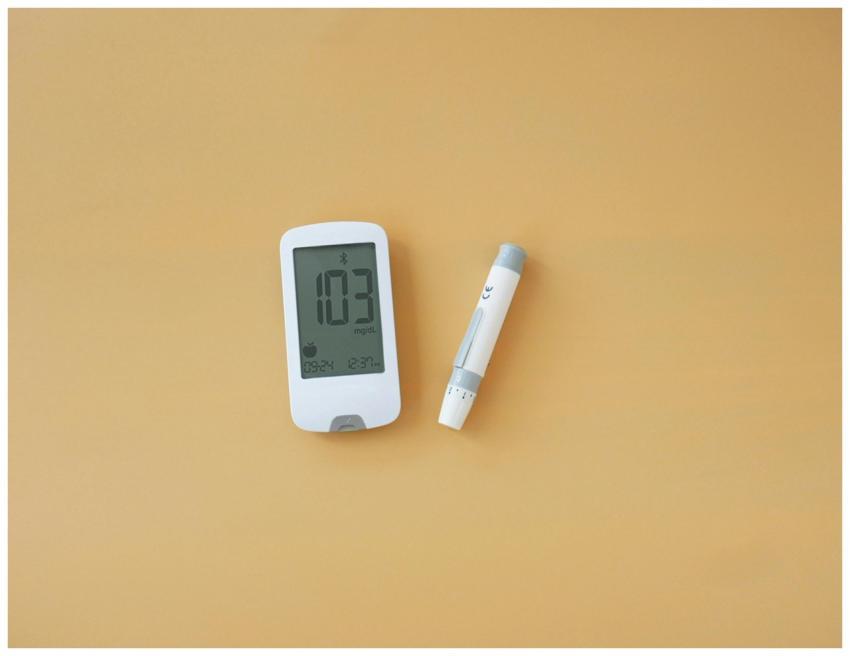 Close-up of a blood glucose meter and lancet pen o