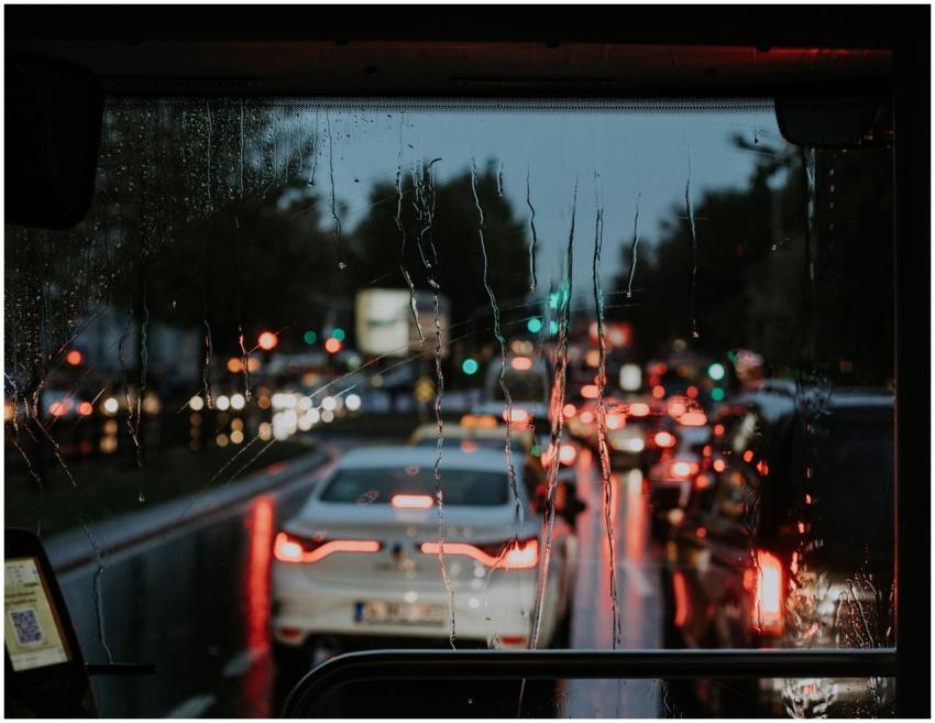 A blurred view of street traffic through a rain-so