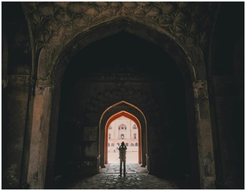 Person silhouetted against an ancient Indian monum