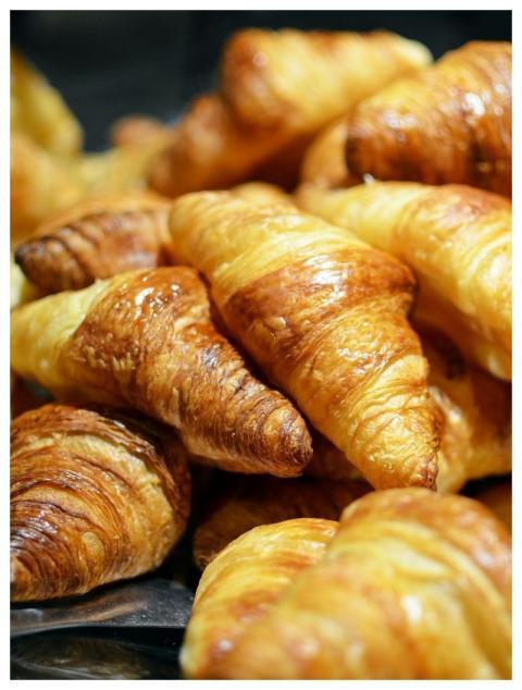 A stack of golden, freshly baked croissants showca