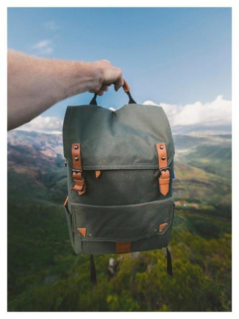 Hands holding traveler's backpack