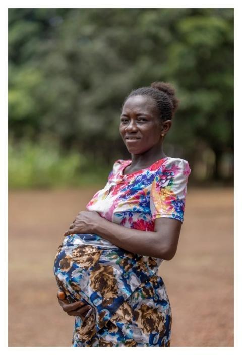 Woman poses outside health facility