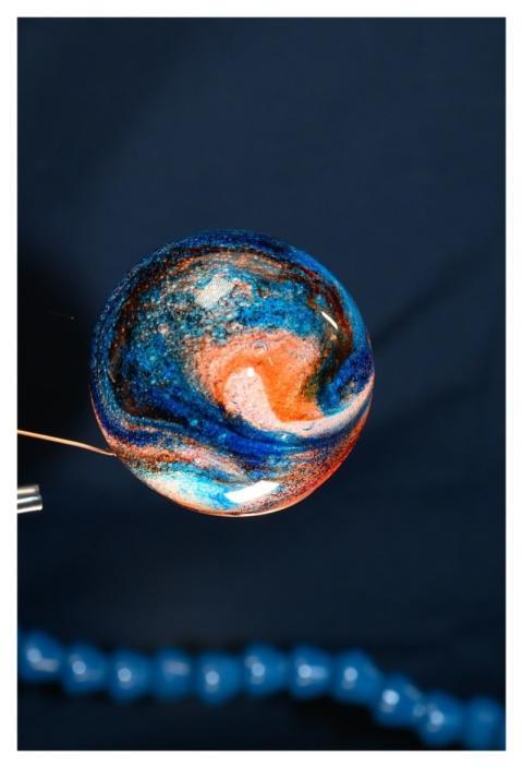 Sphere of water filled with food coloring in micro