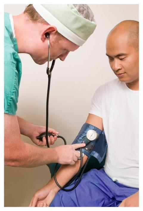 A clinician in the process of conducting a blood p