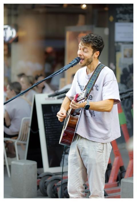 Boy Busker Playing Guitar