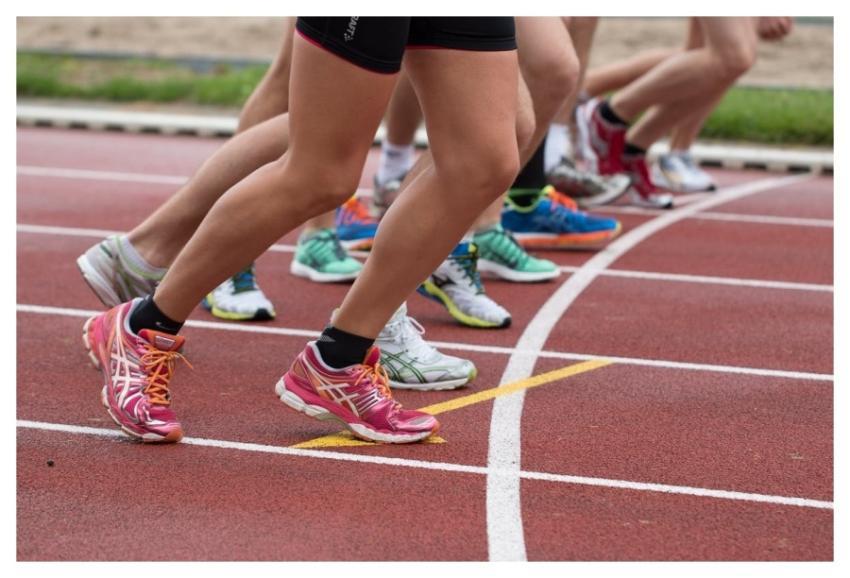 Close-up of athletes' feet at the starting line, p