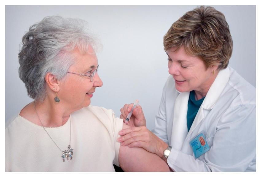 A doctor administering an intramuscular immunizati