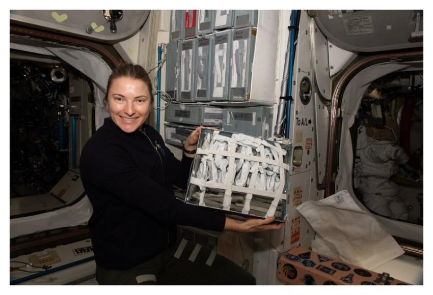 Astronaut Kayla Barron shows off food packets