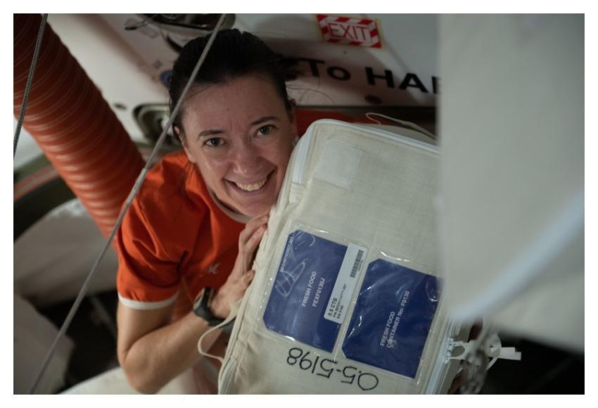 Astronaut Megan McArthur unpacks a fresh food cont