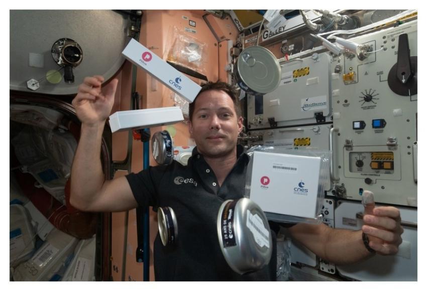 Astronaut Thomas Pesquet seemingly juggles food an