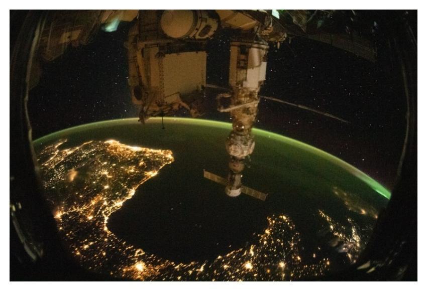 Night time photograph of European coastal city lig