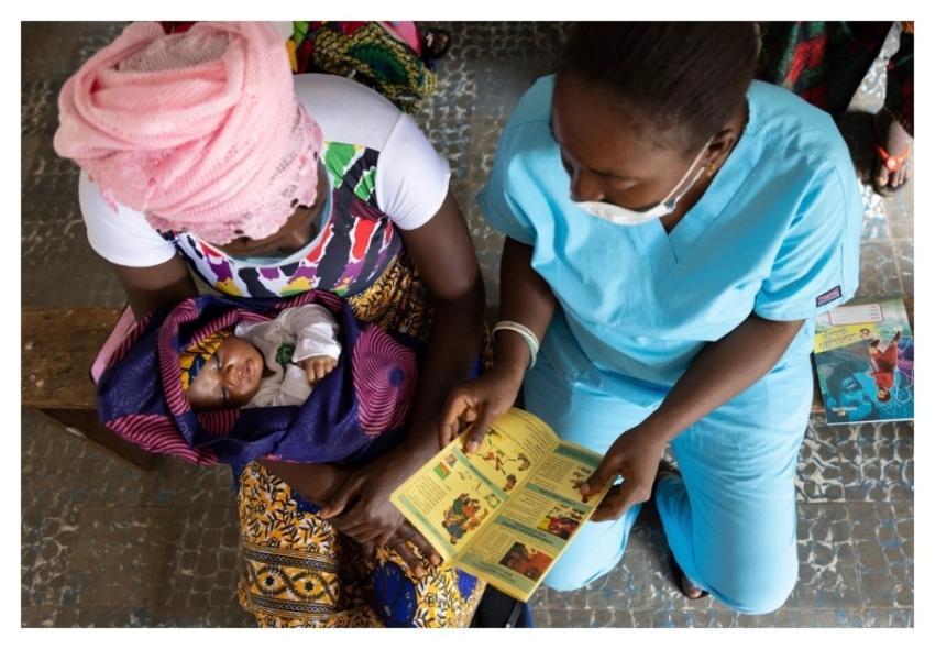 nurse shares educational materials mother
