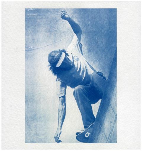 Dynamic cyanotype of a skateboarder in motion at a