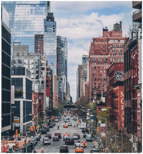 Bustling street scene in NYC with iconic skyscrape