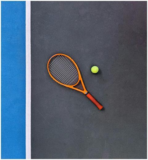 A tennis racket and ball on a court, emphasizing s