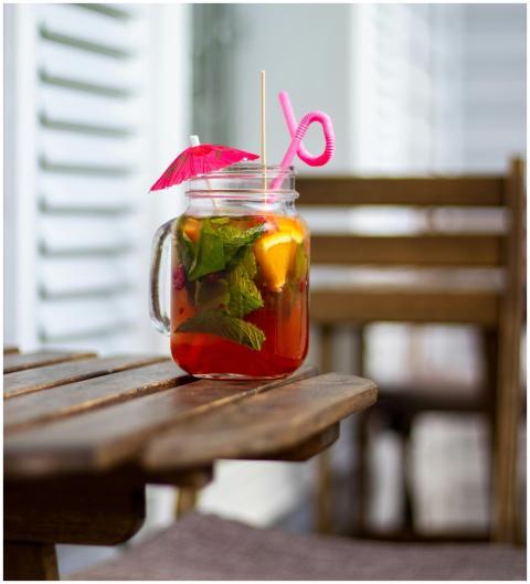 A vibrant tropical drink with mint and fruit in a