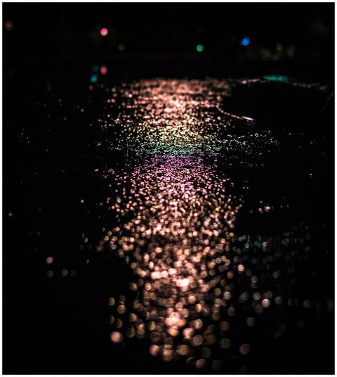 Artistic capture of street lights reflecting on we