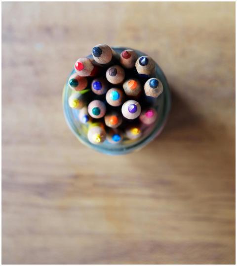 Brightly colored pencils arranged in a jar viewed