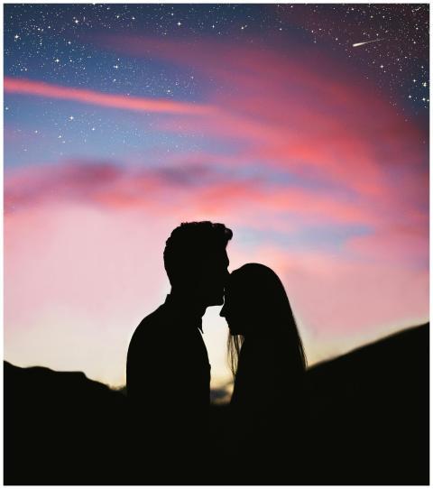 Silhouetted couple sharing an intimate moment agai