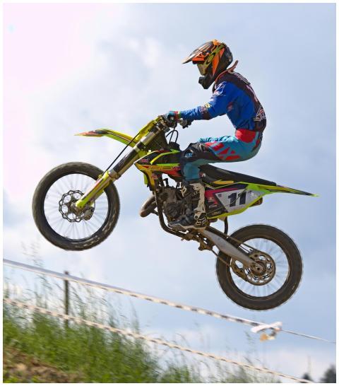 Rider performing an airborne trick on a motocross