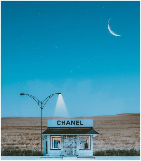 A minimalistic Chanel store illuminated by street