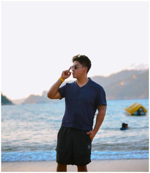 Casual young man in sunglasses standing confidentl