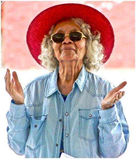 Joyful senior woman wearing a vibrant red hat and