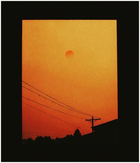 Silhouetted view of smoky orange sunset through wi