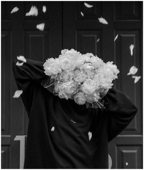 Artistic black and white image of a person holding