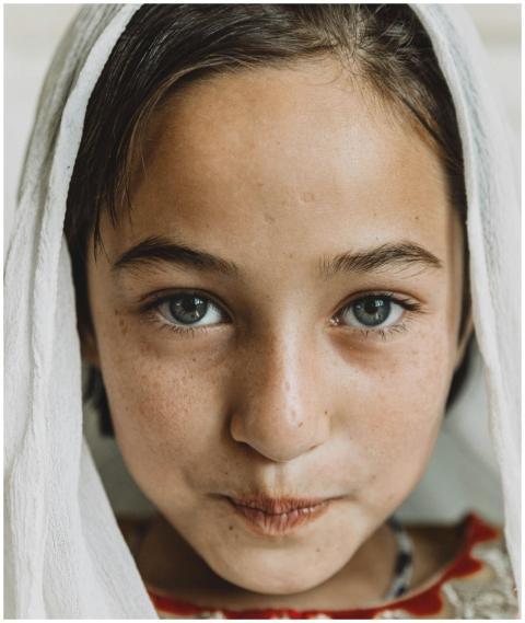 Charming portrait of a young girl with a headscarf
