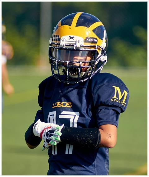 A young American football player in full uniform a