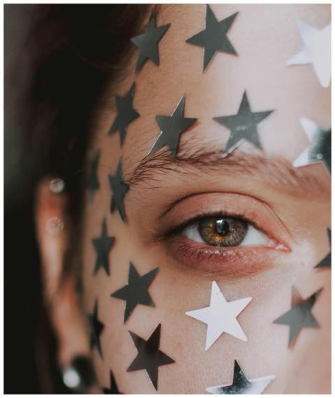 Artistic close-up portrait of a woman with star st